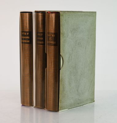 three books sitting on top of a white table next to each other