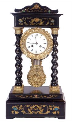a black and gold clock sitting on top of a table