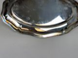 a silver tray with a mirror on it on a table