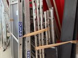 a lot of different types of ladders in a warehouse