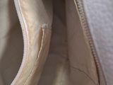 the inside of a white purse with a zipper on it