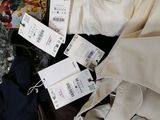 a pile of clothes with price tags on them