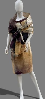 mannequin dressed in gold and black dress with a black bow