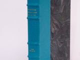 a blue book sitting on top of a white table