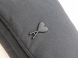a black pillow with a heart on it and a key on it