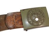 belt with a metal buckle with a seal on it on a white background