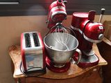 a red mixer and a blender sitting on a counter