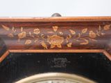 a close up of a clock with a floral design on it