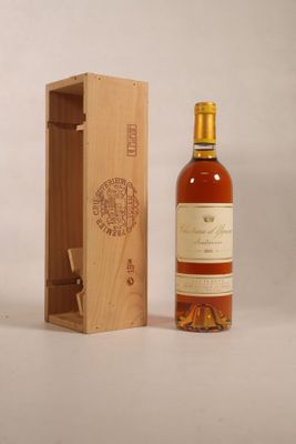 an image of a bottle of wine sitting next to a wooden box