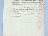 an old document with writing on it sitting on top of a table