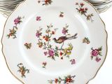 a stack of plates with birds and flowers on them