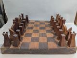a wooden chess board with pieces of wood on it
