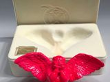 a red angel figurine sitting in a white box