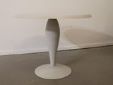 a white table with a white chair in front of it