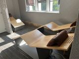 three benches in a room with a window in the background