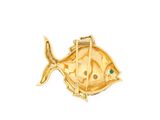 a close up of a gold fish brooch with a green stone