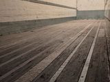 a skateboard that is sitting in the middle of a wooden floor