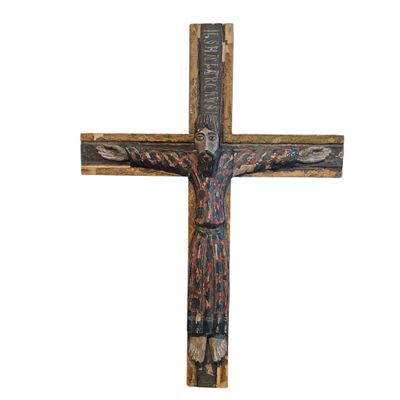 a wooden cross with a man on the cross on top of it