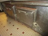 an image of a dirty kitchen with a lot of rust on the floor