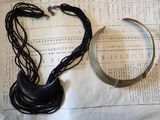 two necklaces and a bracelet laying on a piece of paper