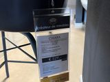 a black chair with a price tag attached to it