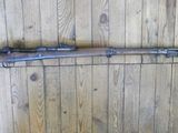a rifle mounted on the wall of a wooden room
