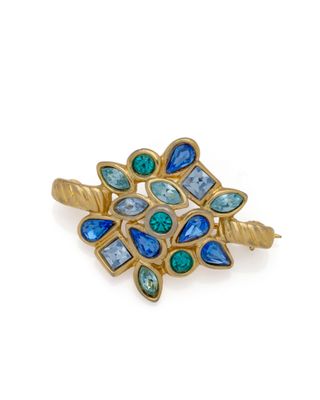 a close up of a gold ring with blue and green stones