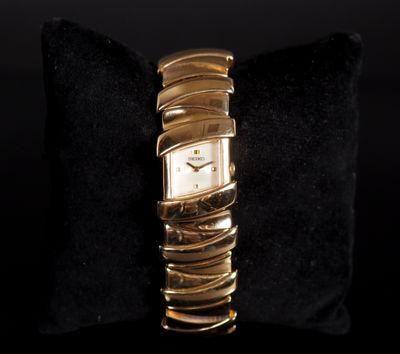 an image of a close up of a wrist watch on a pillow