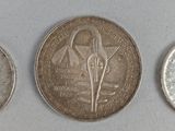 six different types of coins are shown on a white surface