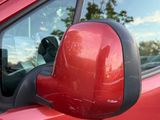 a red car that is parked in the parking lot