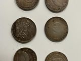 six different british coins are shown on a white surface