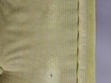a close up of a yellow chair with buttons on the back