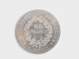 an old silver coin with a wreath on top of it