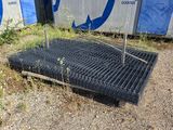 an image of a grate laying on the ground in front of a building
