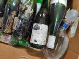 many bottles of wine in a box on the floor