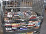 a metal cart with many items in it in a warehouse