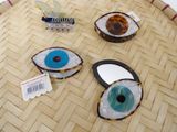 three different types of eye shaped hair clips on the floor