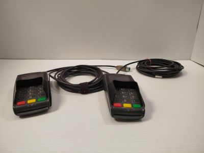 three cell phones are sitting on a table with a cord