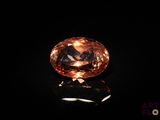 an orange diamond on a black surface