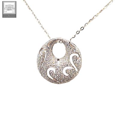 a close up of a silver necklace with a bird on it