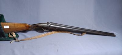 an old gun with a wooden handle and a leather case