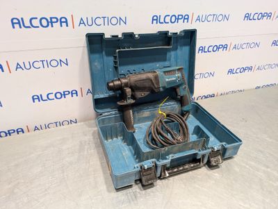 a blue tool box with a drill in it sitting on a table