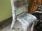 a plastic chair sitting in front of a bike