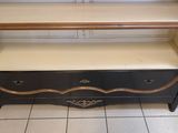 a black and gold bookcase with two drawers