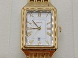 a gold watch with roman numerals on the face