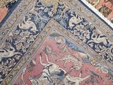 a close up view of a rug with animals on it