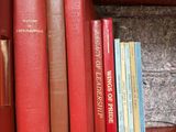 many books that are on a shelf in the room