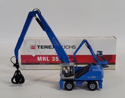 a blue crane that is sitting next to a box