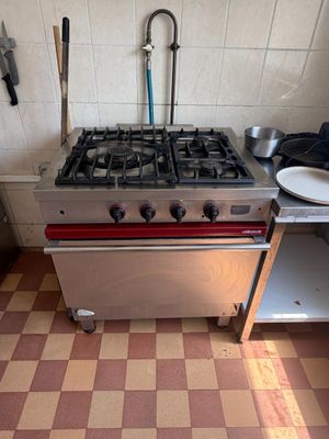 a kitchen with a stove, sink, and dishwasher in it