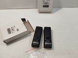 two remote controls sitting on a table next to a box